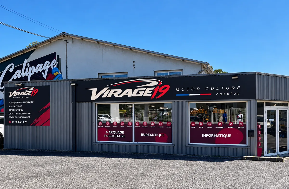Façade de la boutique à Bort-les-Orgues : grande enseigne Virage 19 Motor Culture Corrèze, vitrines marquage publicitaire, bureautique et informatique, fresque Calipage